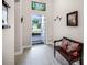 Inviting entryway featuring light wood floors, a decorative bench, and a stained glass window at 4100 Martindale Loop, Winter Haven, FL 33884