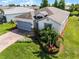 Well-maintained home with beautiful landscaping, brick driveway, and a two-car garage at 4100 Martindale Loop, Winter Haven, FL 33884
