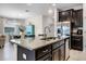 Modern kitchen island features granite countertops and stainless steel appliances at 4100 Martindale Loop, Winter Haven, FL 33884