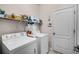 Functional laundry room with modern appliances and plenty of storage space at 4100 Martindale Loop, Winter Haven, FL 33884