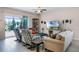 Comfortable living room with stylish furniture, a ceiling fan, and a sliding glass door to the patio at 4100 Martindale Loop, Winter Haven, FL 33884