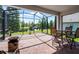Covered patio with brick flooring, outdoor seating, and a beautiful view of the lake at 4100 Martindale Loop, Winter Haven, FL 33884