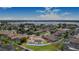 Aerial view showcasing a property with a pool, a well-kept yard, and a lake view in the distance at 413 Ruby Lake Pl, Winter Haven, FL 33884