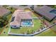 Aerial view of a home featuring a pool, screened enclosure, and well-maintained yard within a fenced perimeter at 413 Ruby Lake Pl, Winter Haven, FL 33884