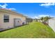 Well-maintained backyard with lush lawn, shed, and screened-in pool area, perfect for outdoor enjoyment at 413 Ruby Lake Pl, Winter Haven, FL 33884