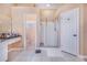 A spacious bathroom showcasing tile floors, a vanity with ample counter space, and a glass-enclosed shower at 413 Ruby Lake Pl, Winter Haven, FL 33884