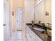 A pristine bathroom featuring a granite vanity, a large mirror, and a walk-in shower and private toilet at 413 Ruby Lake Pl, Winter Haven, FL 33884