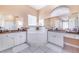 A pristine bathroom featuring tile floors, double sinks, a soaking tub, and a glass enclosed walk-in shower at 413 Ruby Lake Pl, Winter Haven, FL 33884