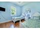 This light and airy bedroom has two beds, a window, and neutral paint for flexible personalization at 413 Ruby Lake Pl, Winter Haven, FL 33884