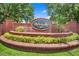 Inviting brick community sign surrounded by manicured landscaping, creating a sense of arrival at 413 Ruby Lake Pl, Winter Haven, FL 33884