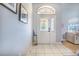 Bright entryway with tile floors, decorative front door, and view into the living area creating a welcoming atmosphere at 413 Ruby Lake Pl, Winter Haven, FL 33884