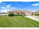 Charming single-story home with well-manicured lawn and landscaping, offering great curb appeal and a welcoming atmosphere at 413 Ruby Lake Pl, Winter Haven, FL 33884