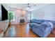 Spacious living room with a fireplace, mounted television, ceiling fan, and comfortable blue sectional sofa at 413 Ruby Lake Pl, Winter Haven, FL 33884