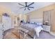 Bright, spacious main bedroom with white furnishings, complemented by a decorative bench and stylish accents at 413 Ruby Lake Pl, Winter Haven, FL 33884