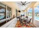 Enjoy the outdoors under this covered patio with a ceiling fan, seating, and access to a swimming pool at 413 Ruby Lake Pl, Winter Haven, FL 33884