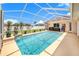 Beautiful pool with lanai, surrounded by lush green landscaping and privacy fencing at 413 Ruby Lake Pl, Winter Haven, FL 33884