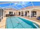 Large in-ground pool is fully screened and is surrounded by a spacious covered patio area at 413 Ruby Lake Pl, Winter Haven, FL 33884