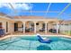 Screened-in pool with covered patio, outdoor kitchen, and plenty of space for relaxing and entertaining at 413 Ruby Lake Pl, Winter Haven, FL 33884