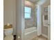 The neutral bathroom is equipped with a shower-tub combination and toilet at 421 Riders Loop, Auburndale, FL 33823