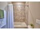 Cozy bathroom showcasing a bathtub with a white shower curtain and tiled walls at 421 Riders Loop, Auburndale, FL 33823