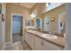 Bright bathroom with double sinks, granite countertop, and views of the bedroom and walk-in closet at 421 Riders Loop, Auburndale, FL 33823