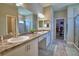 Elegant primary bathroom featuring double sinks, a spacious shower, and access to the walk-in closet at 421 Riders Loop, Auburndale, FL 33823