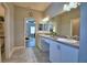 Well-lit bathroom with dual sinks, a large mirror, and neutral color palette at 421 Riders Loop, Auburndale, FL 33823