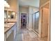 Modern bathroom showcasing a double sink vanity, a glass shower, and a walk-in closet at 421 Riders Loop, Auburndale, FL 33823
