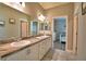 Bright bathroom with double sinks, granite countertop, and views of the bedroom and walk-in closet at 421 Riders Loop, Auburndale, FL 33823