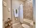 Neutral colored bathroom featuring a shower and tub combination, tile, and artistic decorations at 421 Riders Loop, Auburndale, FL 33823