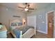 A cozy bedroom featuring modern lighting, a ceiling fan, and a nearby closet for storage at 421 Riders Loop, Auburndale, FL 33823