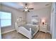 A quaint bedroom featuring modern lighting, a ceiling fan, and well-lit natural light from the nearby window at 421 Riders Loop, Auburndale, FL 33823
