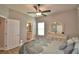 Comfortable bedroom featuring neutral colored walls, wood floors, dresser and a view of the bathroom at 421 Riders Loop, Auburndale, FL 33823