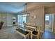 Charming dining area with pool view, bench seating, and a decorative lighting fixture at 421 Riders Loop, Auburndale, FL 33823