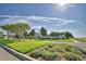 Community entrance with lush landscaping, signage, and well-maintained greenery on a sunny day at 421 Riders Loop, Auburndale, FL 33823