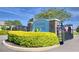 Community entrance sign for Juliana Village with manicured landscaping and decorative flags at 421 Riders Loop, Auburndale, FL 33823