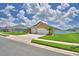 Attractive single-story home with a two-car garage, lush green lawn, and desert landscaping at 421 Riders Loop, Auburndale, FL 33823