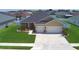 Lovely single-story home with a two-car garage, surrounded by well-maintained landscaping and a lush lawn at 421 Riders Loop, Auburndale, FL 33823