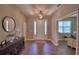 Inviting home foyer with light wood floors, a decorative light fixture, and modern decor at 421 Riders Loop, Auburndale, FL 33823
