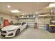 Spacious garage with a white car, epoxy floor, and storage racks for organization at 421 Riders Loop, Auburndale, FL 33823