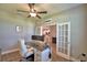 This bright office space features a French door view of the kitchen at 421 Riders Loop, Auburndale, FL 33823
