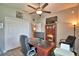 Spacious home office with a ceiling fan, large desk, closet, and bright walls at 421 Riders Loop, Auburndale, FL 33823