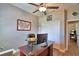 Functional home office with a ceiling fan, framed map, desk, and comfortable seating at 421 Riders Loop, Auburndale, FL 33823