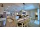 Open-concept living space featuring a modern kitchen, dining area, and comfortable seating by the fireplace at 421 Riders Loop, Auburndale, FL 33823