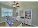 Home office with a large desk, white storage, bright window, and a ceiling fan at 421 Riders Loop, Auburndale, FL 33823