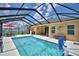 Spacious lanai featuring a sparkling pool and outdoor seating areas under a screened enclosure at 421 Riders Loop, Auburndale, FL 33823