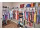 Bright walk-in closet with organized shelving, hanging racks, and storage for clothes and accessories at 421 Riders Loop, Auburndale, FL 33823