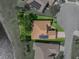 Aerial view of a one-story home with lush landscaping and solar panels in a lakeside neighborhood at 4356 Ashton Club Dr, Lake Wales, FL 33859