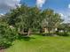 Spacious backyard with a large, well-maintained lawn and mature trees providing shade and privacy at 4356 Ashton Club Dr, Lake Wales, FL 33859