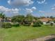 Expansive backyard featuring mature trees and lush green lawn near the water at 4356 Ashton Club Dr, Lake Wales, FL 33859